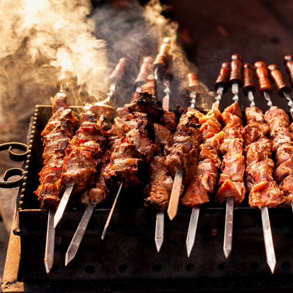 Smoking hot chicken skewers on a grill